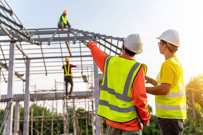 bigstock--Workers-In-Construction-Site-455403355